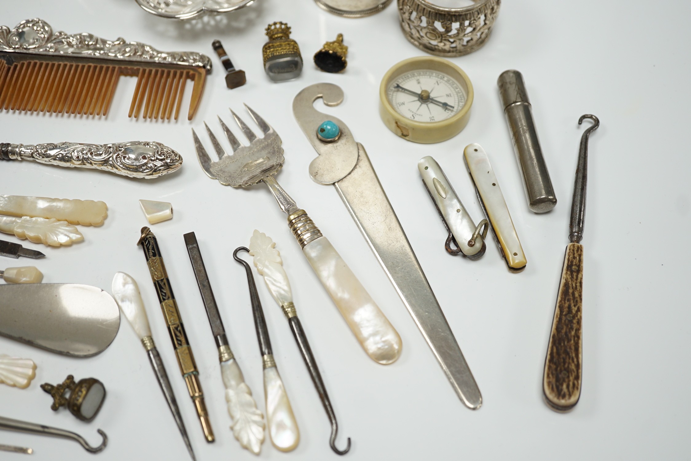 A group of assorted small silver and white metal items, including a small late Victorian clover shaped nut dish, napkin rings, pill box, etc and other items including two gilt metal mounted chalcedony fob seals.